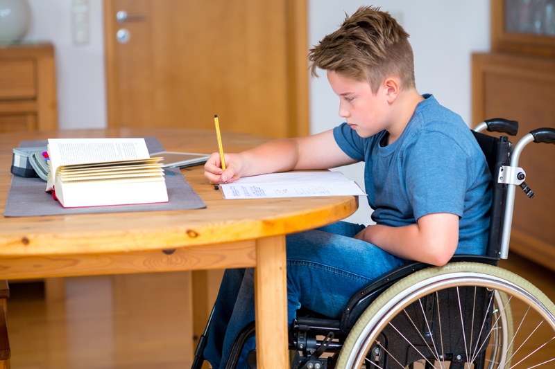 Student in a wheelchair doing homework
