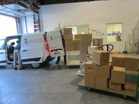 volunteers loading a van in a warehouse